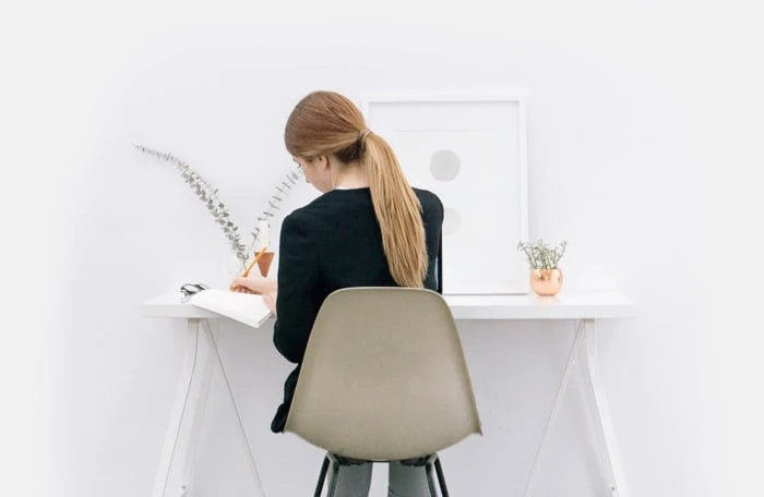back of woman working at a desk
